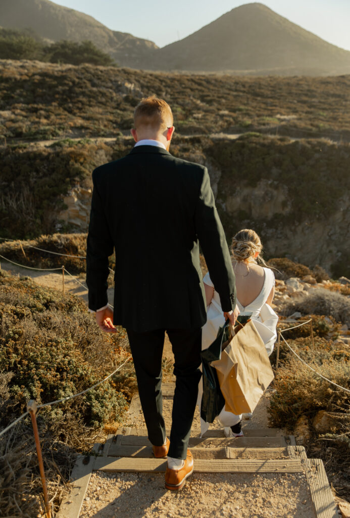 Couple walking down coastal trail at Garrapata State Park during Big Sur elopement
