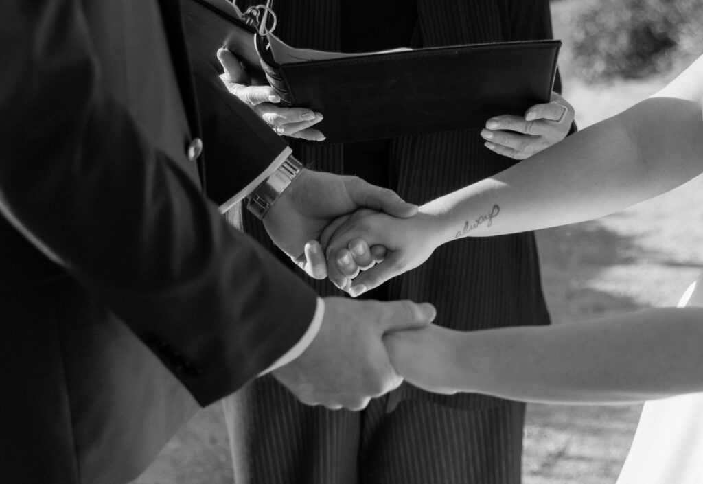 Close-up of couple holding hands during Big Sur elopement ceremony
