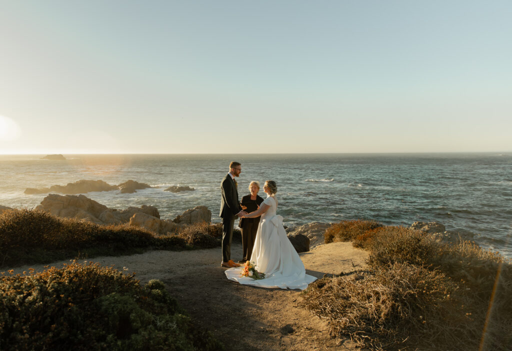 Couple exchanging vows at Garrapata State Park during Big Sur elopement ceremony during sunset