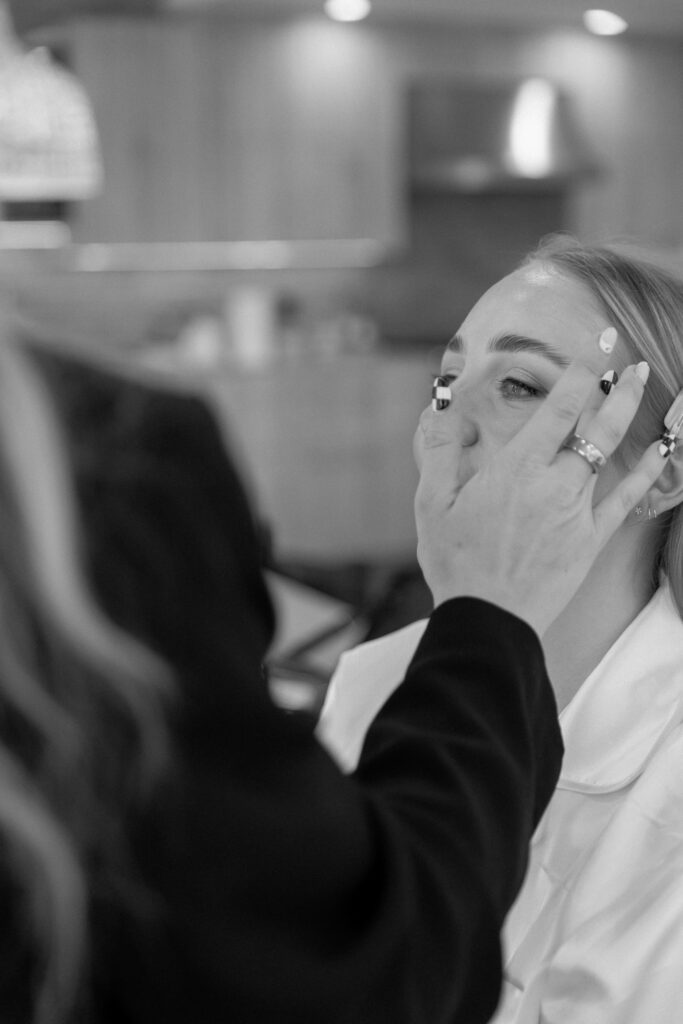 Bride getting makeup done at Big Sur Airbnb before elopement