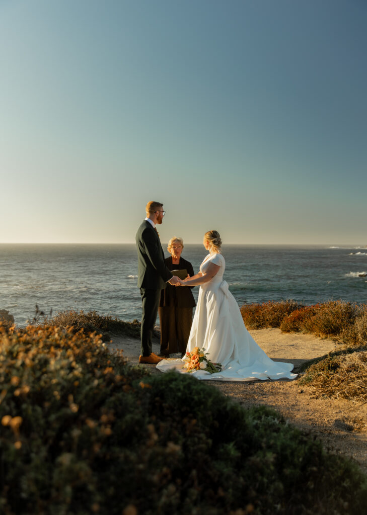 Couple exchanging vows at Garrapata State Park overlooking the ocean in Big Sur