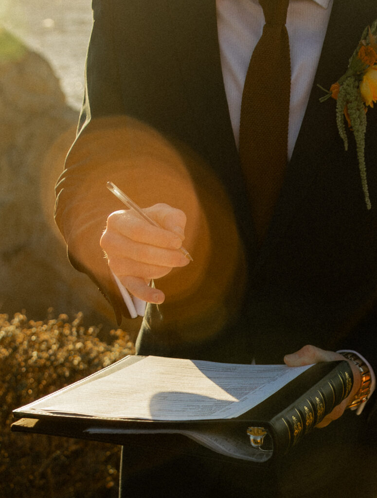Groom signing marriage license at Garrapata State Park during Big Sur elopement