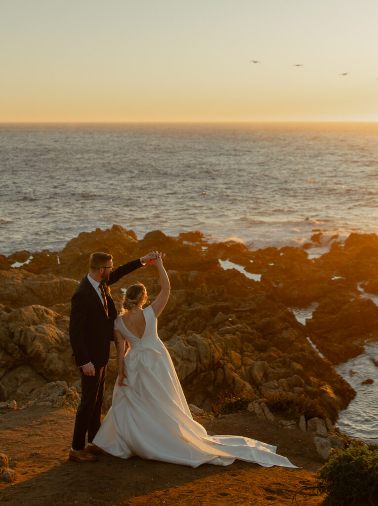 Bride twirling on coastal cliffs at Garrapata State Park during Big Sur elopement