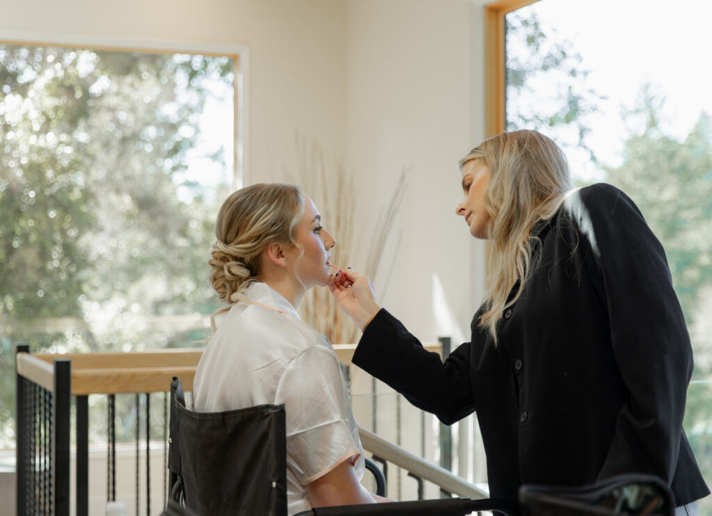 Bride getting makeup done at Big Sur Airbnb before elopement