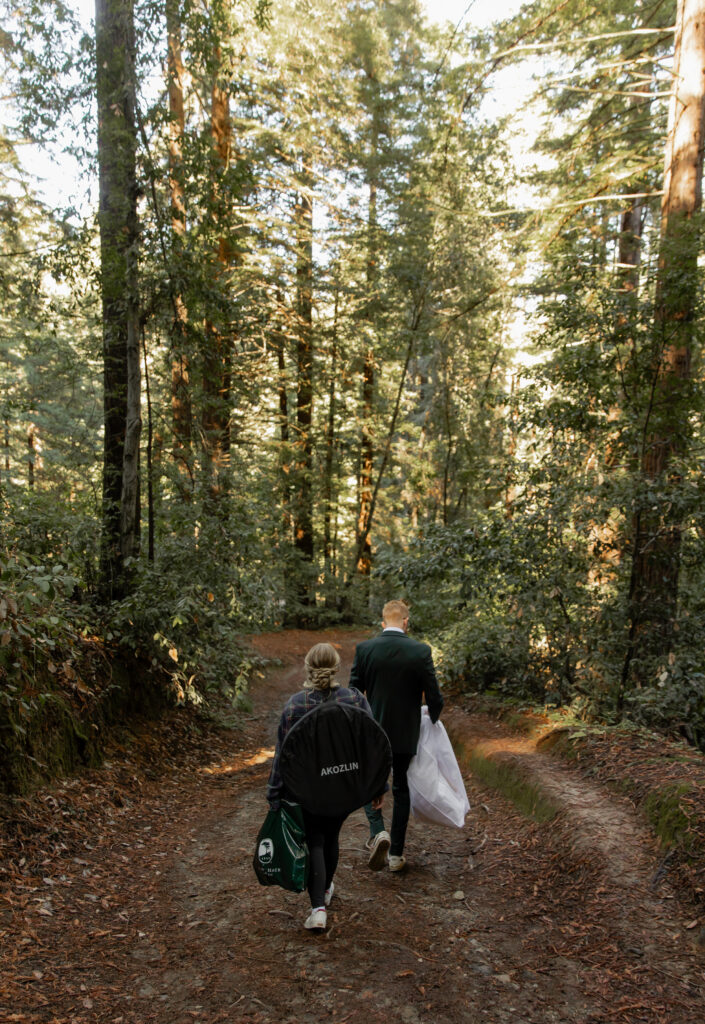 Couple walking through redwoods in Big Sur before elopement ceremony