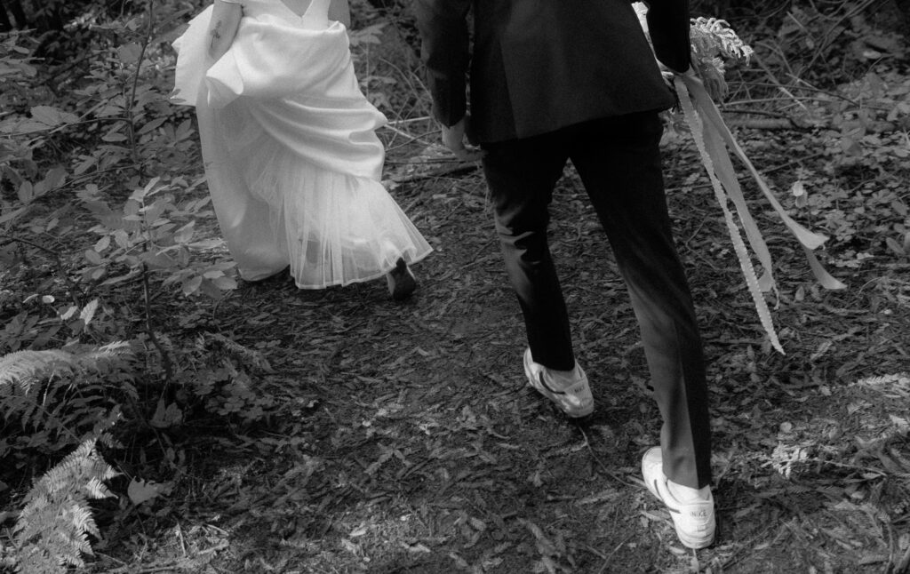 Couple walking through redwood forest in Big Sur during elopement