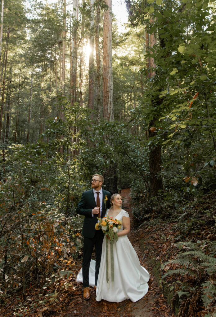 Couple walking through redwood forest in Big Sur during elopement