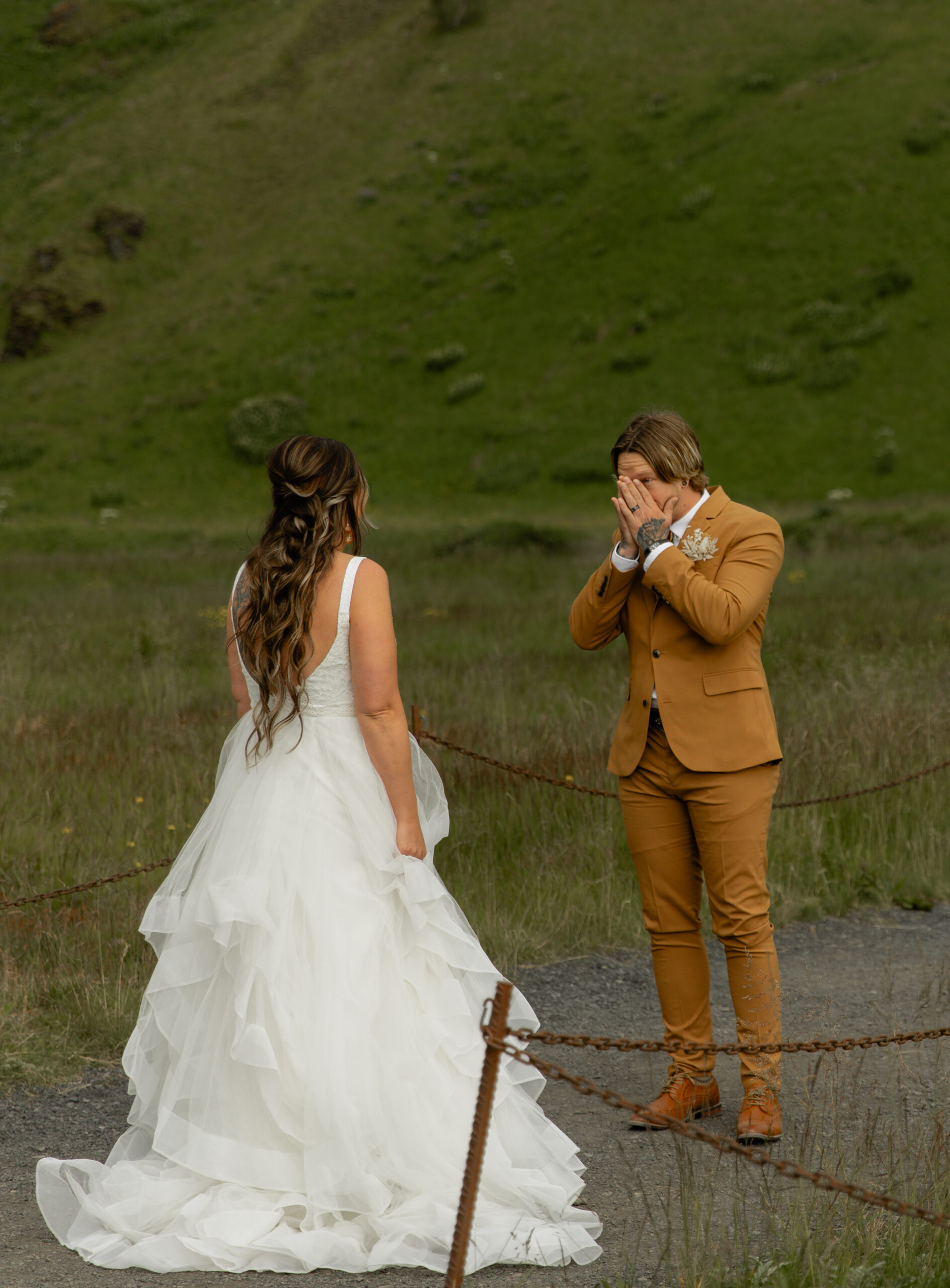 Bride and groom reacting during first look beside Skógafoss waterfall in Iceland