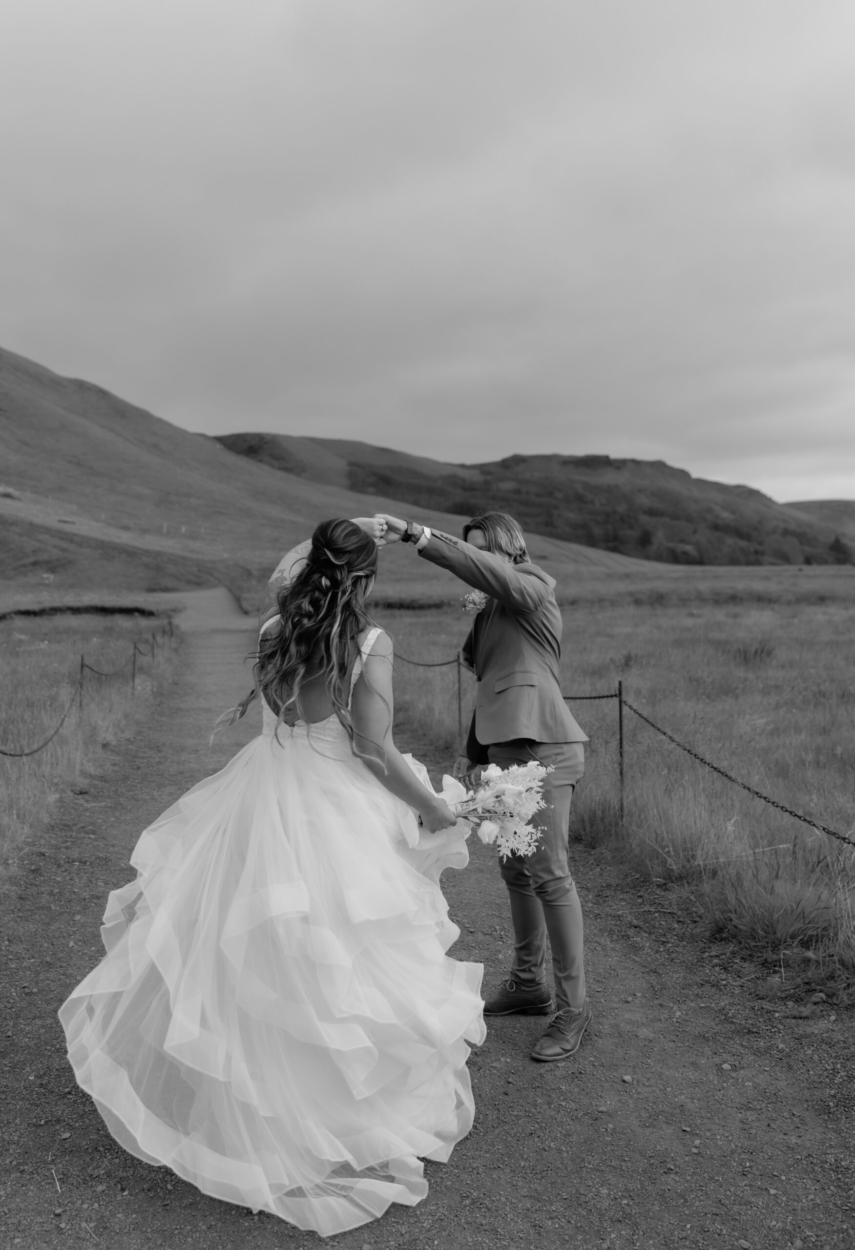 Black and white photo of bride twirling during Iceland elopement portraits
