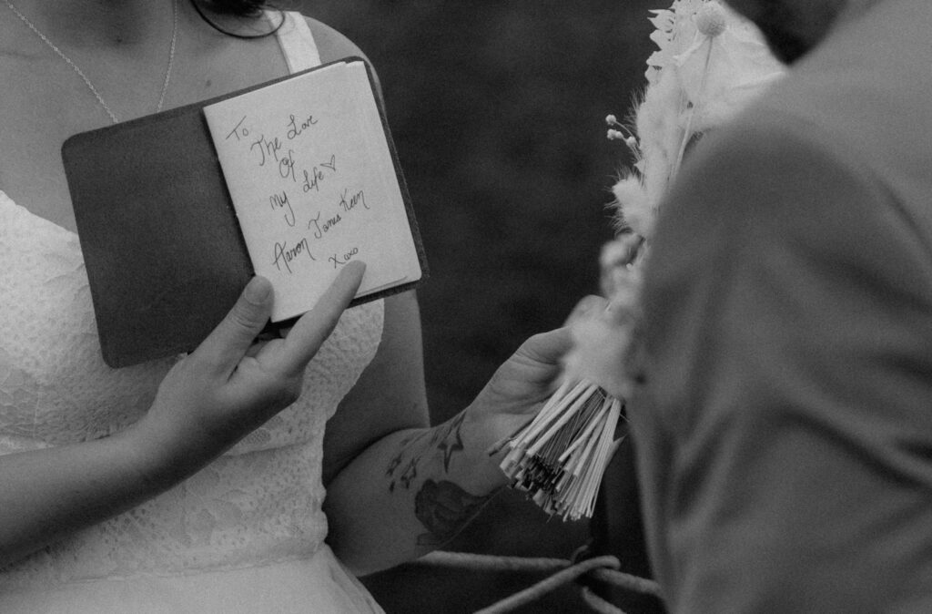 Black and white detail photo of handwritten vows during intimate Iceland ceremony
