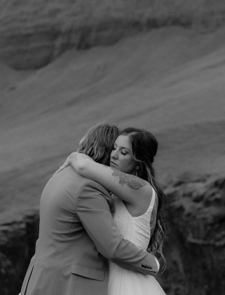 Black and white portrait of bride and groom embracing during intimate Iceland elopement
